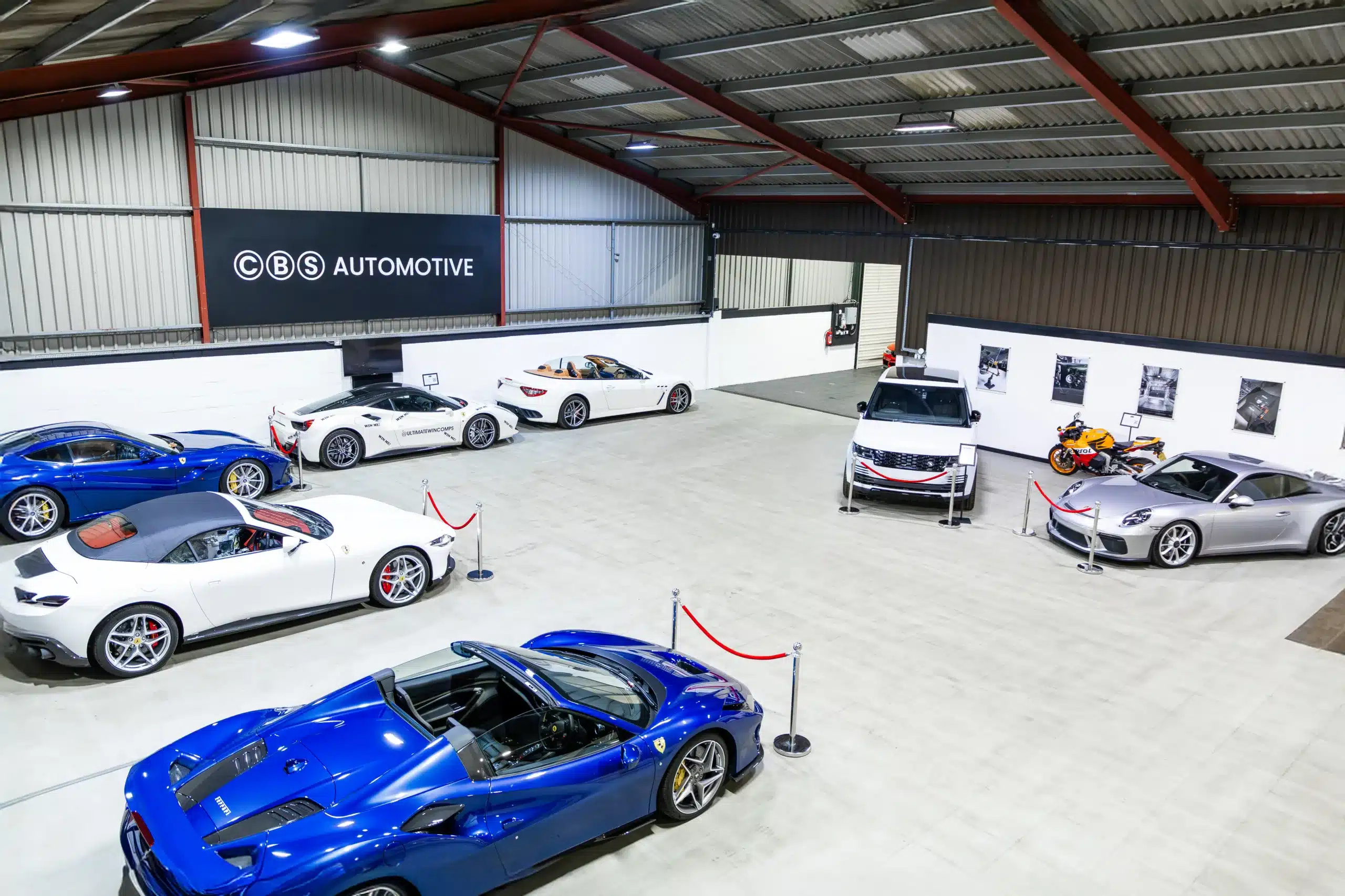 CBS Automotive workshop showing multiple supercars